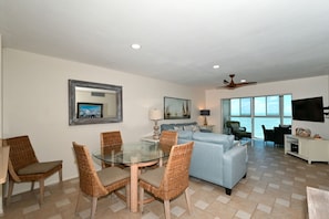 Spacious living room with HDTV, view to Lanai, beach and Gulf of Mexico