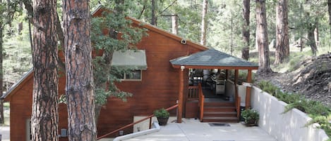 Surrounded by mature trees, the cottage has a designated parking spot.