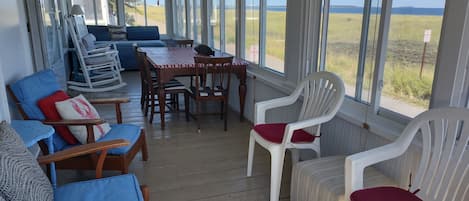 The front porch overlooks the dunes and 7 miles of sandy beach.