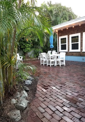 Patio area with outdoor lounging & dining areas. Solo stove fire pit and BBQ.