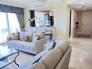 Living room, view into kitchen and a high bar and ocean view