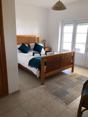 Master bedroom with doors to large balcony