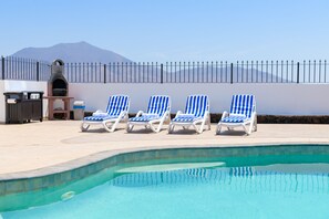 Outside sun lounger and barbecue area with Femes mountains backdrop 