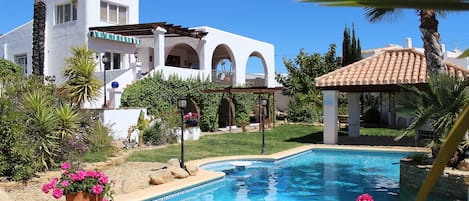 View from the east of the property showing the private pool and bar area