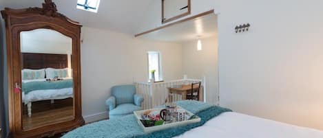 large and airy bedroom - with writing table at top of stairs 