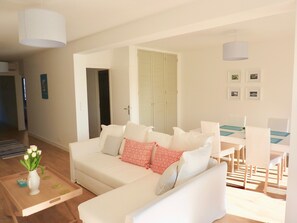 Living area with sofa which converts into double bed.