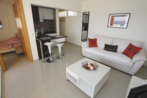 Living area,kitchen with bar desk and bar chairs