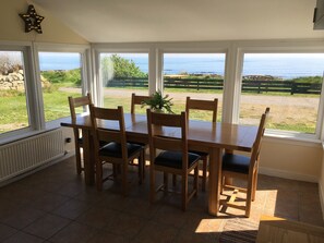 Dining porch with seating for 6 and uninterrupted views across the Moray Firth