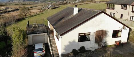 Aerial view showing the house and setting