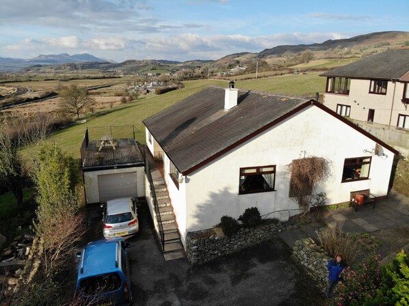 Aerial view showing the house and setting