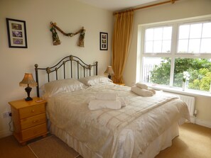 Comfortable, bright Master bedroom with bay and mountain views and ensuite bathroom