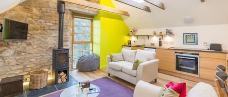 Lounge and kitchen area, light streaming in from roof lights and new windows