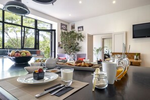 Petit déjeuner dans le cuisine avec vue sur le jardin.