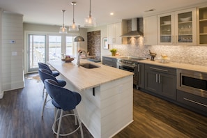 Unique, custom travertine on the island with stainless steel appliances.