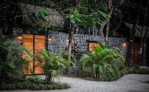 custom 8 ft stone wall surrounds the property