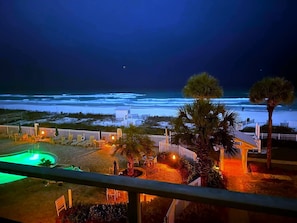 Sterling Sands night view of the pool/hot tub and beach.