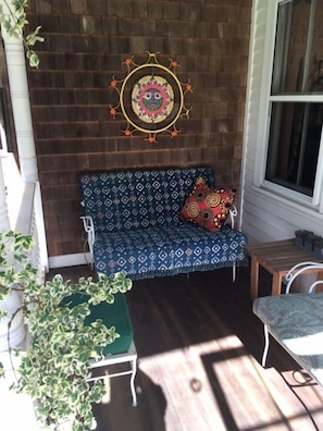 Front porch has comfortable furniture on which to have coffee or read a book