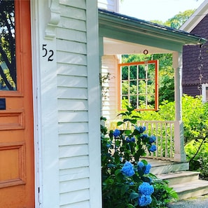 Sunny front porch with hydrangea.