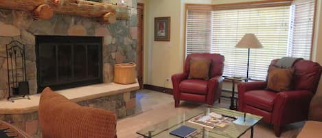 Living Room with Stone Fireplace, Bay Window, Door to Patio and 46" HDTV