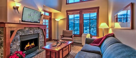 Living Room with gas fireplace, vaulted ceilings and LED HDTV.