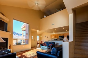 Living room with cathedral ceilings and 2 BIG picture windows.