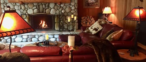 Enjoy a cozy fire in River's Edge Chalet's majestic river rock fireplace.