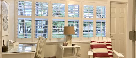 The sunroom with a view of the tropical boulevard.