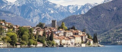 The Rezzonico Village and its Castle seen from Como Lake; behind the mountains.