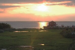 Sunset over bay and marsh viewed from upper deck