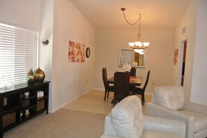 Dining room located adjacent to the kitchen and living room, hardwood floors 