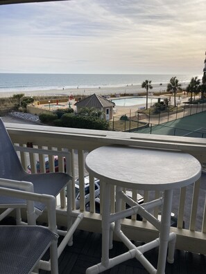 Balcony view with 4 tall sling chairs and table