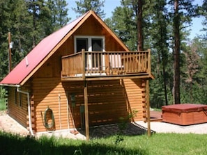 A second deck off the back of the cabin and the hot tub.