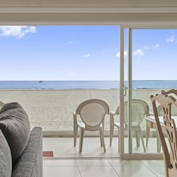 Sliding glass doors open to let in the gentle ocean breezes. Due to the moderate climate, this home, like most in the area, does not include central air.