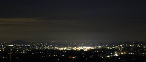 nighttime view from deck overlooking valley below