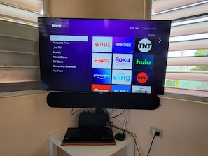 Samsung smart TV with roku, blue ray dvd player and yamaha sound bar