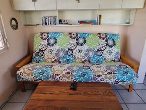 Living room futon folds down to queen size bed