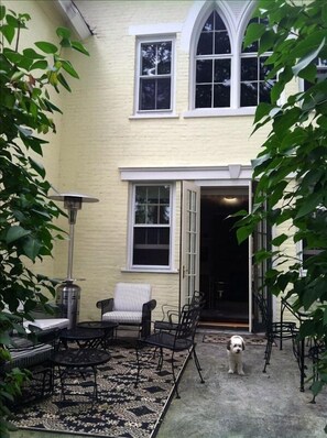 Front patio with grilling, dining and sitting areas leading to living room.  