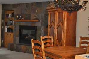 Dining area, flat tv cabinet and fireplace.  