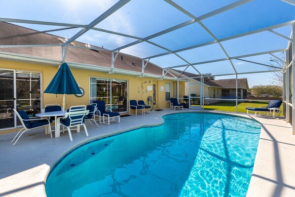 Pool during the day with plenty of space between houses.