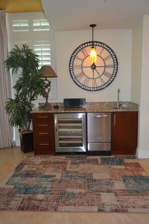 Bar Area with wine cooler/ice maker and sink.