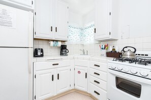 The kitchen comes stocked with dishes, utensils, cookware, bakeware, and large/small appliances.
                