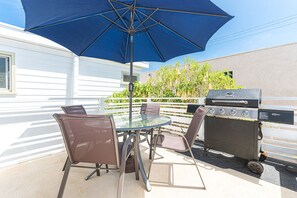 Enjoy a morning cup of coffee or evening cookout on this home's rear deck.
                