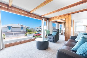 The main living area features full length picture windows, for a bright and cheery interior.
                