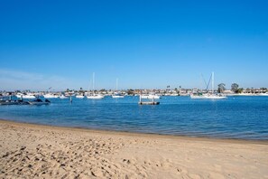 View of the bay beach in front of your rental. Watch the sailboats drift past or get lost in your favorite book.
                