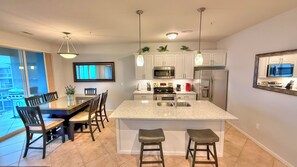 Open floor plan gives views of lake from living room, dining area, and kitchen