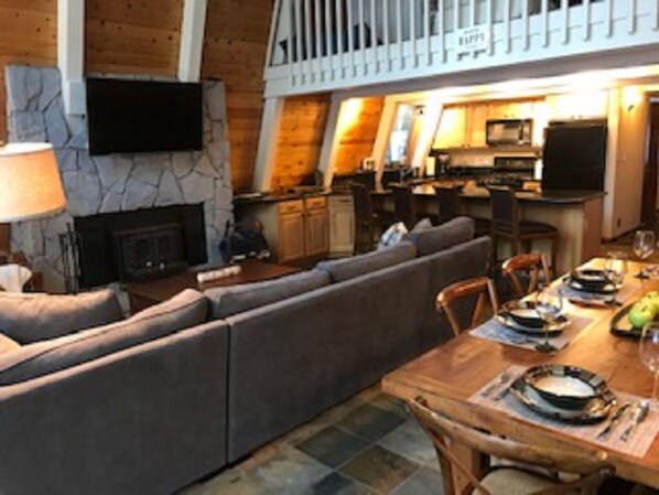 Large family room with fireplace and big screen TV. 
