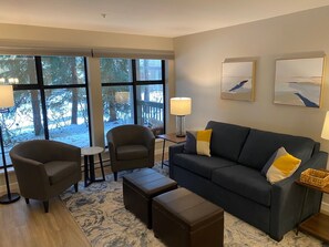 Living area.  Sofa pulls out to a queen sleeper.  A glimpse of the patio.