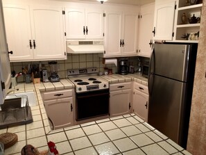 Spacious kitchen includes refrigerator, dishwasher, oven/stove top and microwave