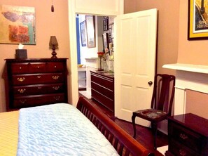Looking from bedroom into the hallway with bathroom to the left of the doorway.