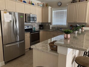 Updated kitchen with stainless appliances, granite counters